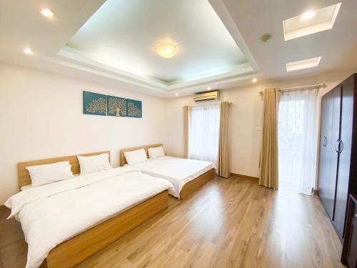 a bedroom with a large bed in a room at Econest Boutique Apartment in Hanoi