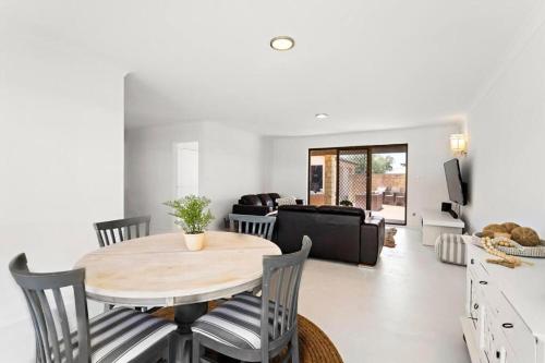a kitchen and living room with a table and chairs at Relaxing Getaway Beachfront Access Multi Family Pets Mandurah in Mandurah