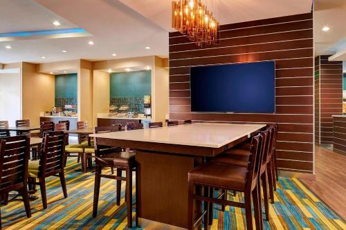 a conference room with a large table and a flat screen tv at Fairfield Inn & Suites by Marriott San Diego Carlsbad in Carlsbad