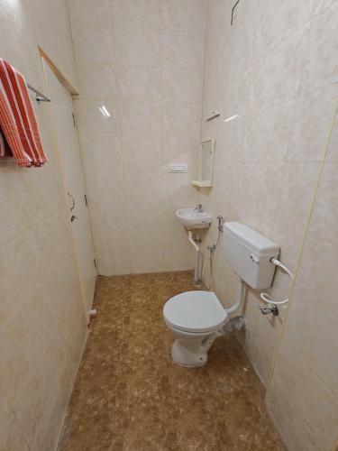 a bathroom with a toilet and a sink at HOTEL SAl INN - NEAR AIRPORT in Chennai