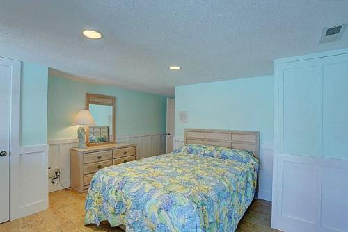 a bedroom with a bed and a dresser and a mirror at 3035 - Morning View in Southern Shores