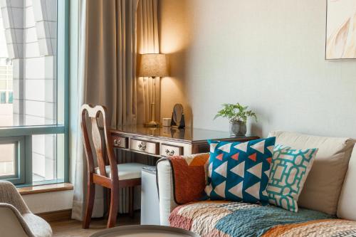 a living room with a couch and a desk at Artistic Studio in Taichung
