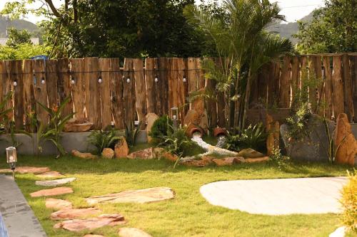 a backyard with a wooden fence and a garden at Big Homie Garden in Thanh Cao
