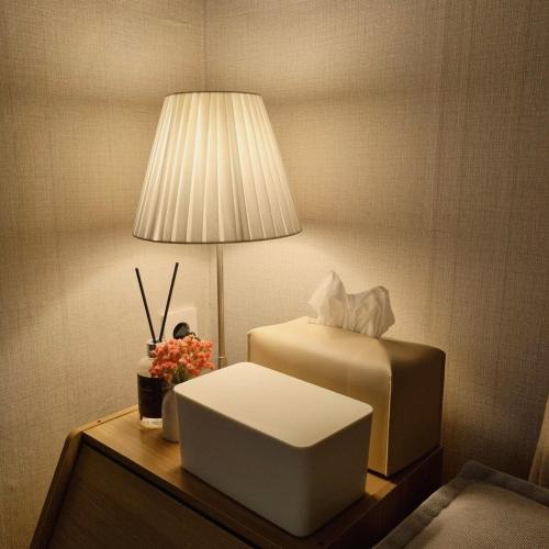 a room with a bed and a lamp on a table at Dear Home in Daegu