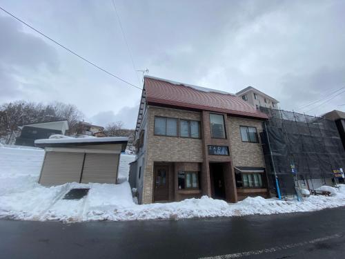 a building on the side of a street with snow at Zao Base スキー場から徒歩1分 in Yamagata