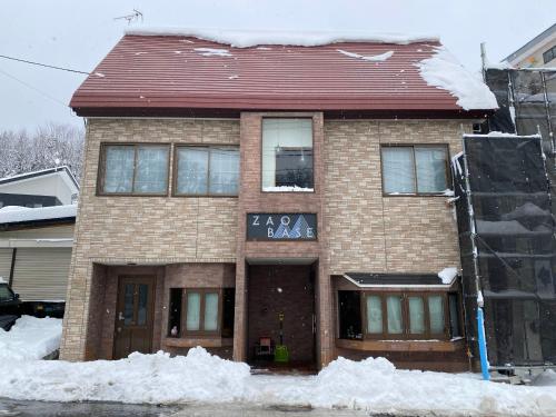 a brick house with snow on the ground at Zao Base スキー場から徒歩1分 in Yamagata