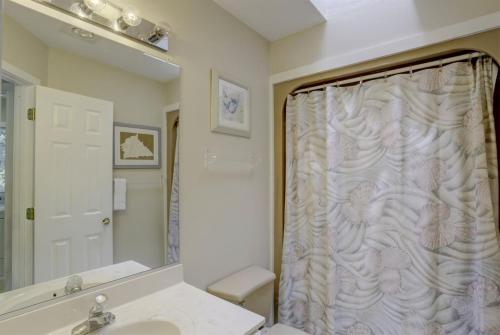 a bathroom with a shower curtain and a sink at 2012 - Grateful Duck in Duck