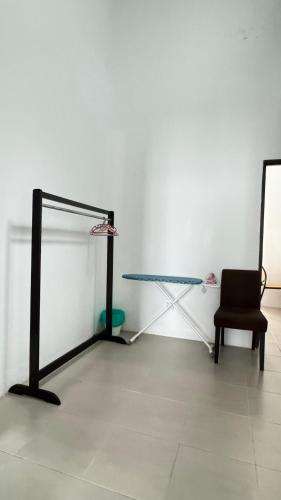 a glass table and a chair in a room at LestariHome1, KLIA Sepang in Sepang