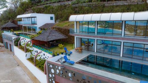 an aerial view of a building with a swimming pool at La Canopée vue sur mer in Nosy Be