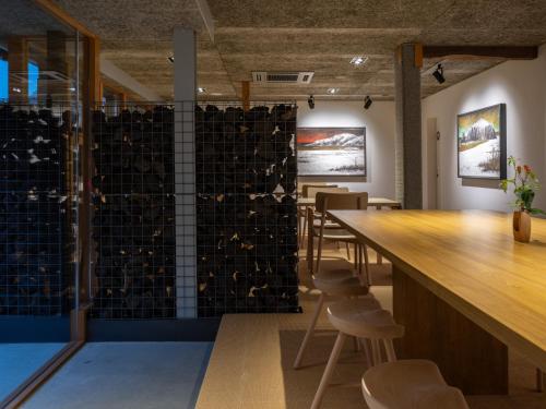 a bar in a room with a counter and chairs at TSUCHIYA Kinosaki onsen in Toyooka