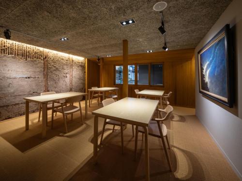 a classroom with tables and chairs in a room at TSUCHIYA Kinosaki onsen in Toyooka