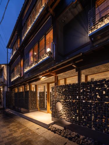 a building with a lit up facade at night at TSUCHIYA Kinosaki onsen in Toyooka
