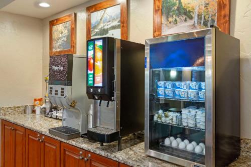 a kitchen with a refrigerator with a television on it at Comfort Inn Richfield I-70 in Richfield