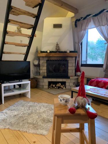 a gnome sitting on a chair in a living room at Vila Krnjević Jastrebac in Buci