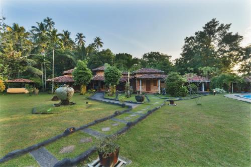 a house with a yard with a garden sidx sidx sidx sidx at River View Villas in Aluthgama