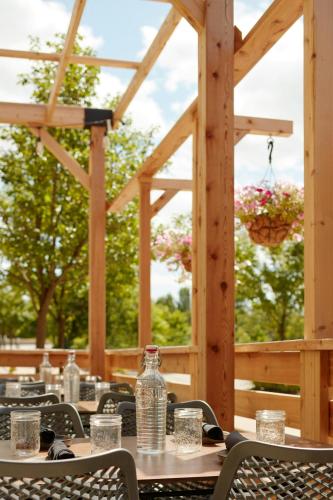 a table with chairs and water bottles on a patio at Delta Hotels by Marriott Guelph Conference Centre in Guelph
