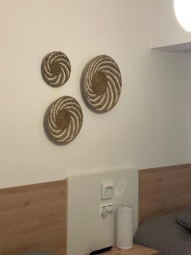 three brown coils on the wall of a bedroom at Marusía apartamento in Malpica
