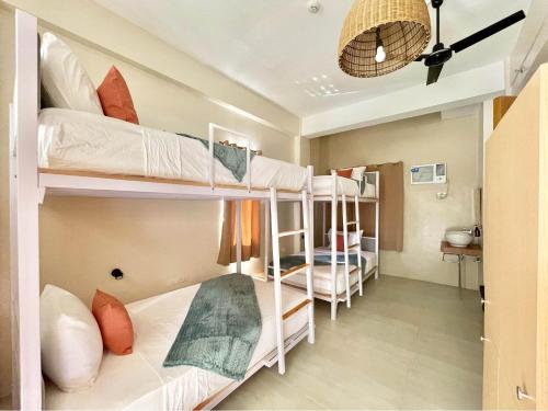 a dorm room with bunk beds in it at Barco El Nido Hotel in El Nido