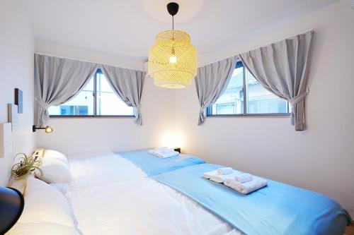 a bedroom with a bed with towels on it at Manere in Tokyo