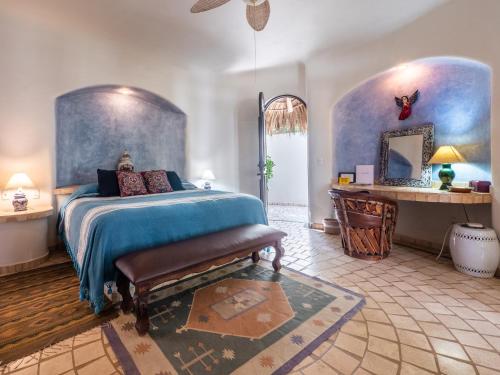a bedroom with a bed and a tub in it at Casa Hafiz in Sayulita