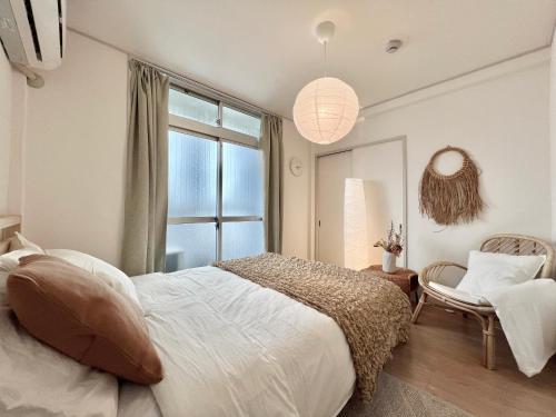 a bedroom with a large bed and a window at shinjuku yichun hostel in Tokyo