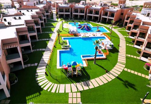 an aerial view of a swimming pool at a resort at Aquamarine Kuwait Resort(Families Only) in Al Nuwaiseeb