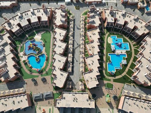 an overhead view of a city with buildings and pools at Aquamarine Kuwait Resort(Families Only) in Al Nuwaiseeb