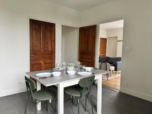 a white dining room table with chairs and wine glasses at LOustal d Henri 3 chambres in Luc