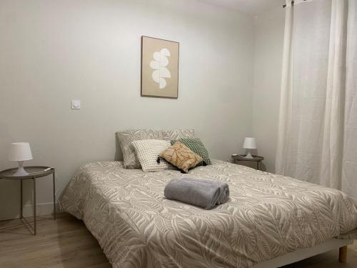 a bed in a bedroom with two tables and two lamps at LOustal d Henri 3 chambres in Luc