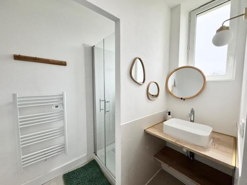 a white bathroom with a sink and a mirror at LOustal d Henri 3 chambres in Luc