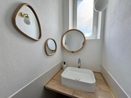 a bathroom with two mirrors and a sink at LOustal d Henri 3 chambres in Luc