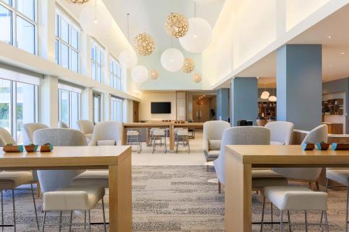 a conference room with tables and chairs and a television at Element Ontario Rancho Cucamonga in Ontario