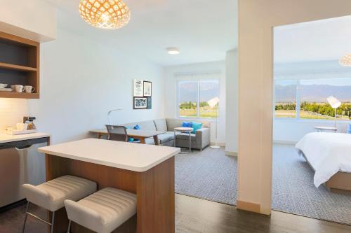 a hotel room with a bed and a living room at Element Ontario Rancho Cucamonga in Ontario