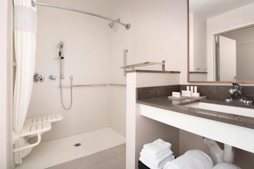a white bathroom with a sink and a mirror at Fairfield Inn & Suites by Marriott Miami Airport West/Doral in Miami