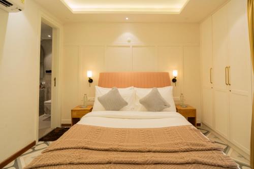 a bedroom with a large bed with two night stands at ELIVAAS Solace Azure 4 BHK Villa with Pvt Pool in Calangute