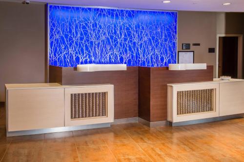 a large screen with a blue painting on a wall at Fairfield Inn & Suites by Marriott Easton in Easton