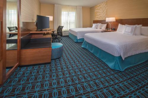 a hotel room with two beds and a flat screen tv at Fairfield Inn & Suites by Marriott Easton in Easton