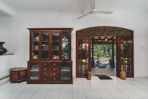 a room with a large wooden cabinet and doors at River View Villas in Aluthgama