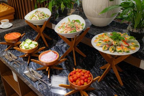 a buffet with plates of food on a table at Langco Bay Retreat in Lang Co