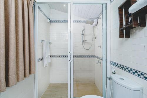 a bathroom with a shower and a toilet at River View Villas in Aluthgama