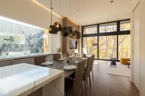 a kitchen and dining room with a table and chairs at The Fount Niseko in Niseko