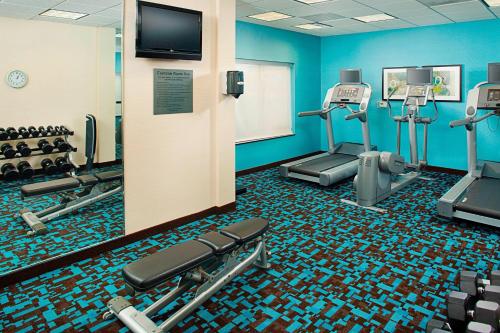 a gym with several tread machines and a flat screen tv at Fairfield Inn & Suites by Marriott San Antonio SeaWorld / Westover Hills in San Antonio