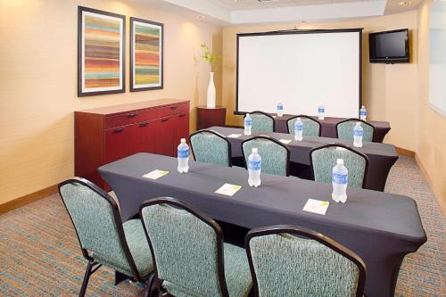 a conference room with tables and chairs and a white screen at Fairfield Inn & Suites by Marriott San Antonio SeaWorld / Westover Hills in San Antonio