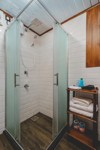 a shower with a glass door in a bathroom at River View Villas in Aluthgama