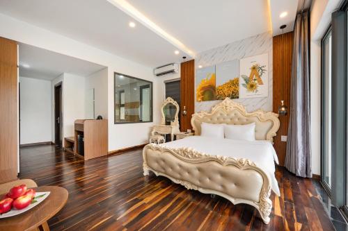 a bedroom with a large white bed and a table at Langco Bay Retreat in Lang Co