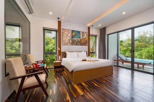 a bedroom with a bed and a table and chairs at Langco Bay Retreat in Lang Co