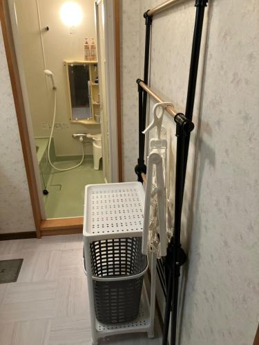 a room with a glass door with a trash can at Private Lodging KASE 五所川原 in Goshogawara