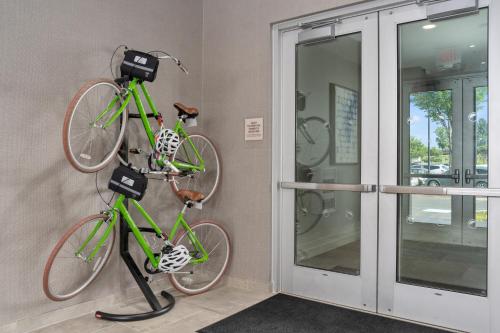 two bikes hanging on a wall next to a door at Element Hampton Peninsula Town Center in Hampton