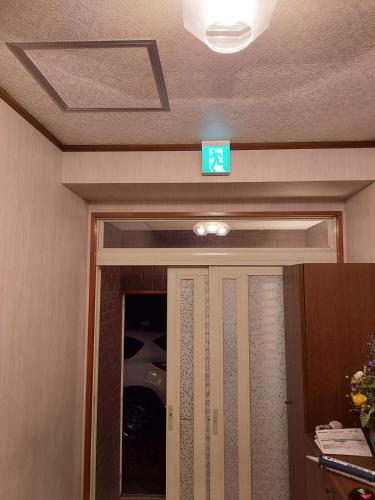 a sign above a door with a sign above it at Private Lodging KASE 五所川原 in Goshogawara