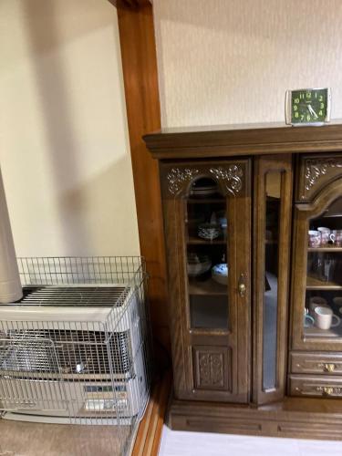 a wooden cabinet with a cage in front of it at Private Lodging KASE 五所川原 in Goshogawara